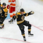 Boston Bruins defenseman Hampus Lindholm (27) celebrates his goal with teammate center Tyler Johnson (90) against the Calgary Flames during first period NHL action at TD Garden.