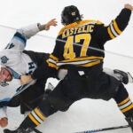 Boston Bruins center Mark Kastelic (47) battles Utah’s Robert Bortuzzo in the 2nd period.