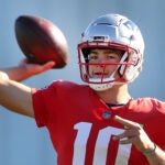 Drake Maye fires a pass during a drill.