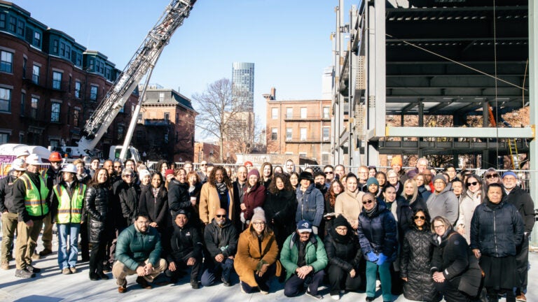 Community members pose in front of La CASA's future site.