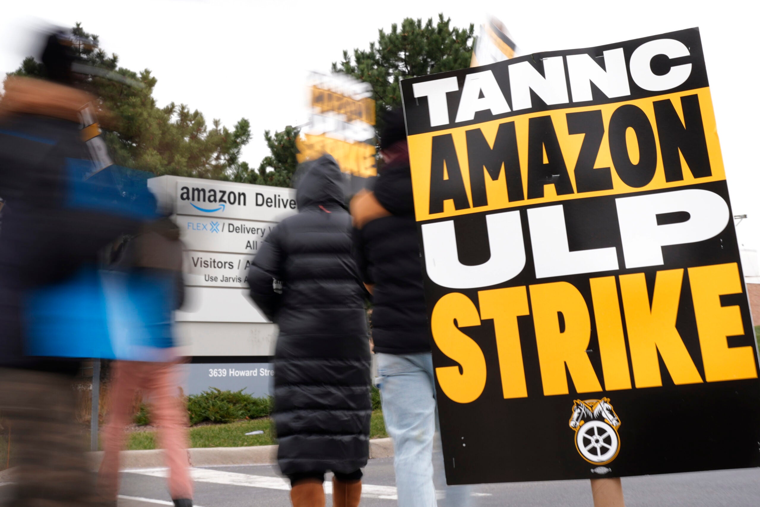 Strikers hold signs during a strike at Skokie (DIL7) Amazon Delivery station in Skokie, Ill.