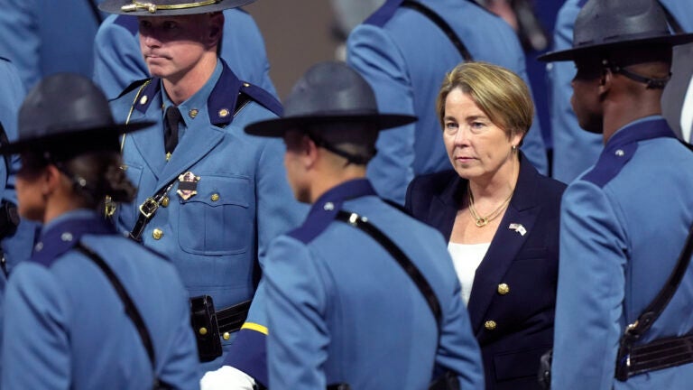 Massachusetts Gov. Maura Healey, right, walks among members of the 90th Recruit Training Group of the Massachusetts State Police.