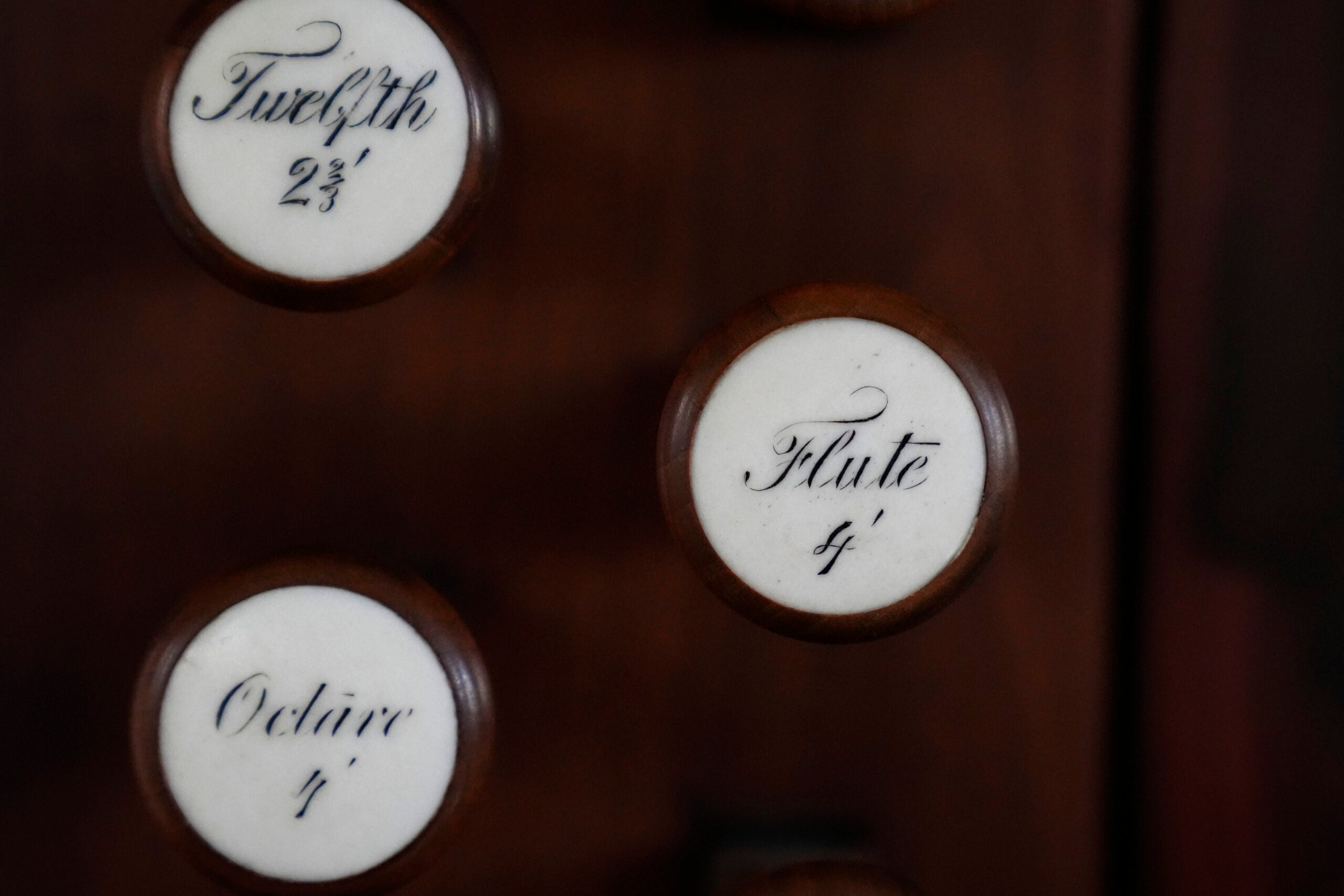 Knobs on an 18th century organ are attached to a wood panel at Old North Church.