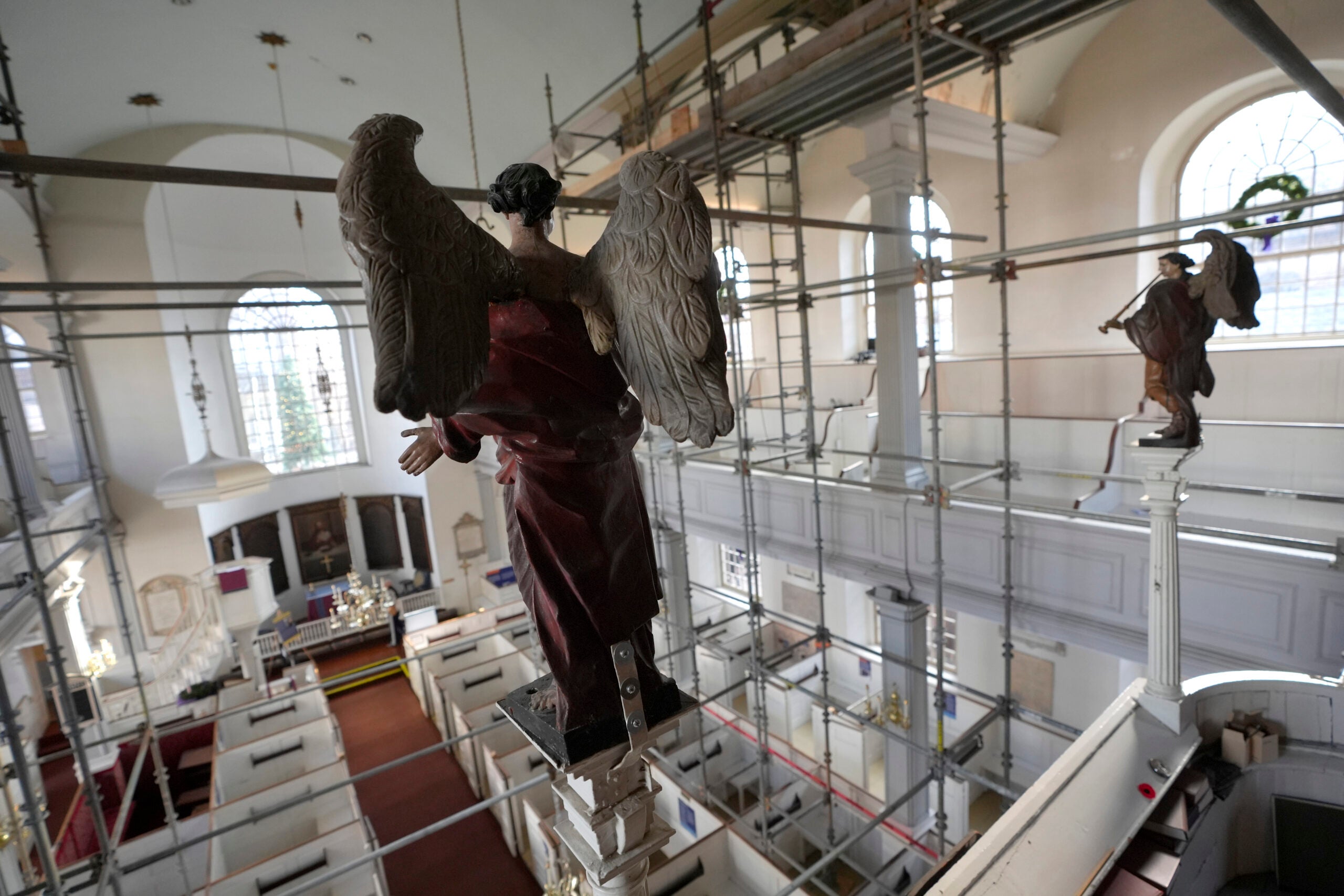 Statues of angels rest in an elevated positions.