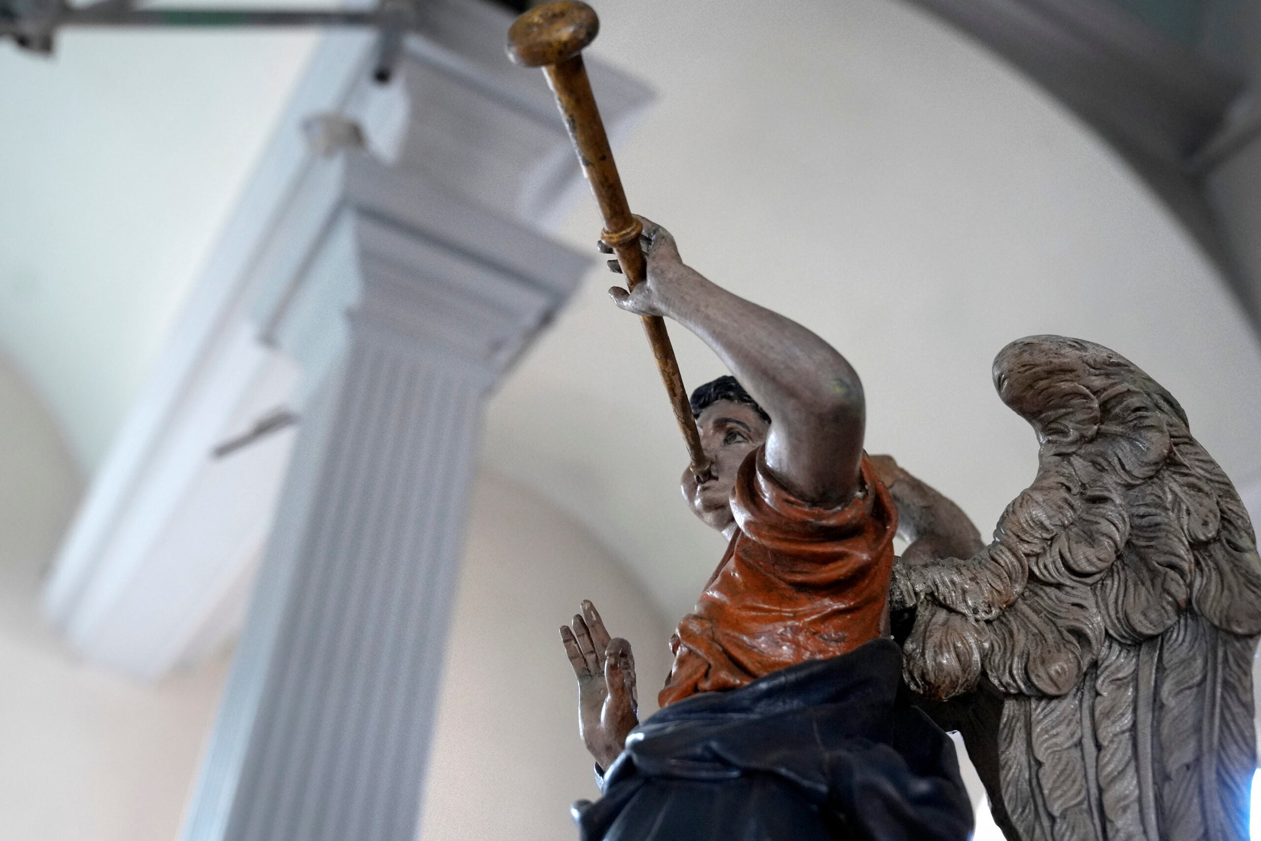 A statue of an angel rests in an elevated position at Old North Church.