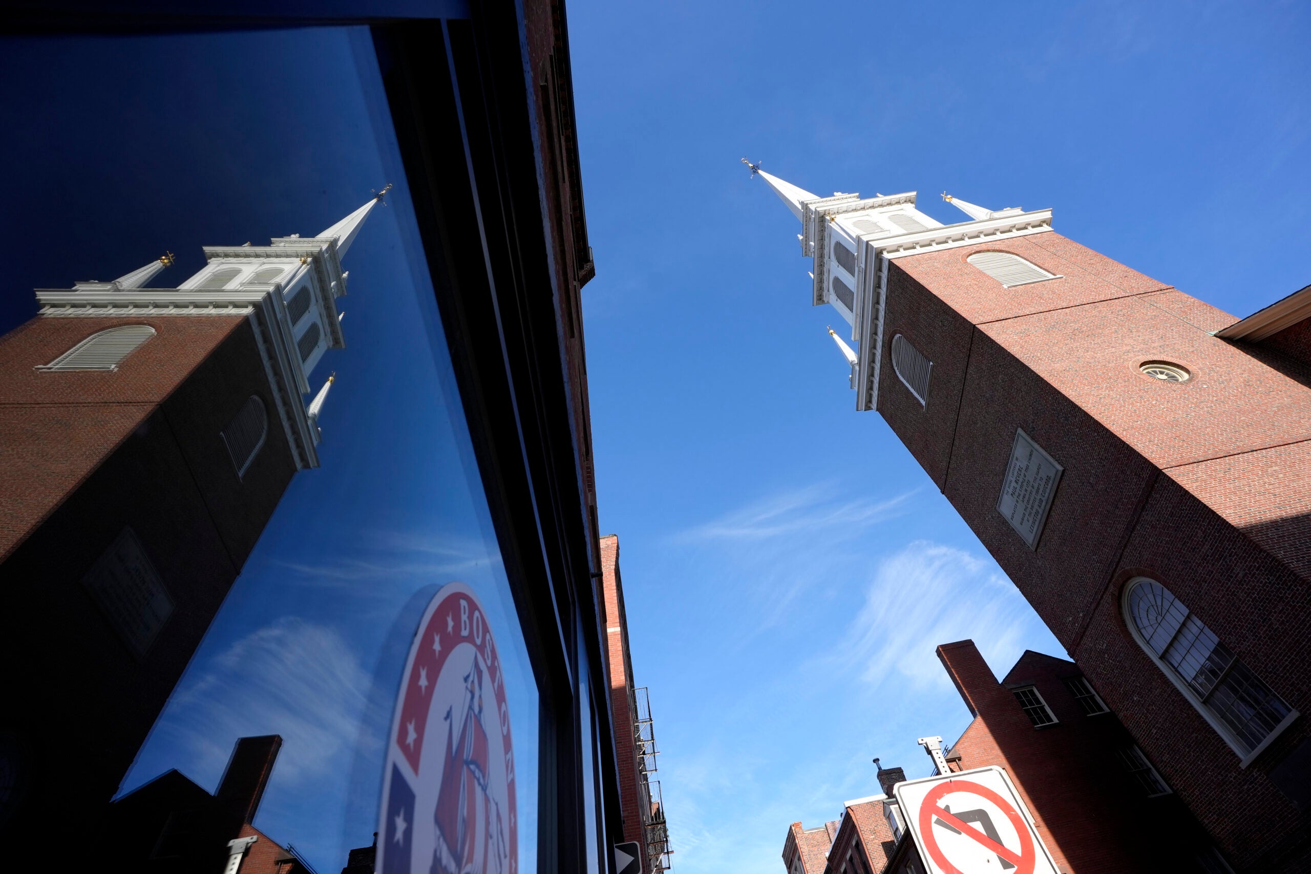 Old North Church is reflected in a storefront window.