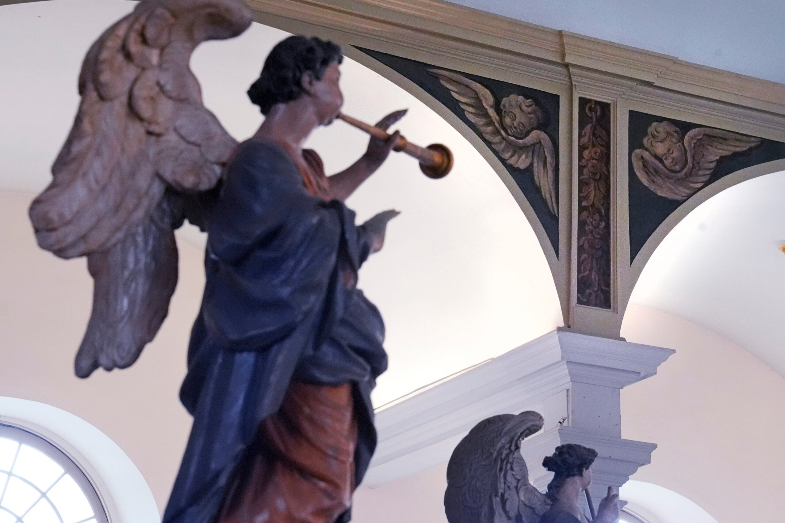 Recently restored, nearly 300-year-old painted angels, at top right, adorn an arch.