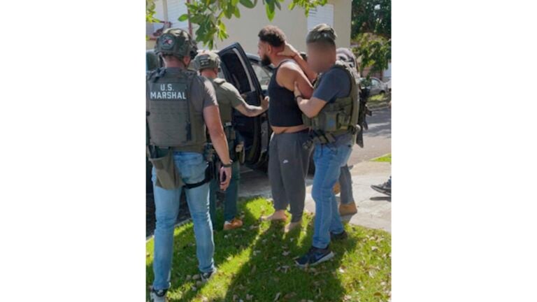 Officers arrest Lance Morales in Puerto Rico.