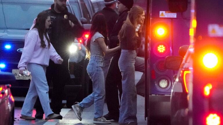 Students board a bus as they leave the shelter following a shooting at the Abundant Life Christian School, Monday, Dec. 16, 2024.