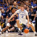 Cooper Flagg handles the ball as Auburn's Tahaad Pettiford defends.