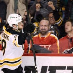 David Pastrnak celebrates his game-winning goal in overtime against the Flames.