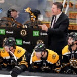 Boston Bruins interim head coach Joe Sacco calls to his players during the first period of an NHL hockey game against the Vancouver Canucks, Tuesday, Nov. 26, 2024, in Boston.