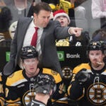 Boston Bruins interim head coach Joe Sacco points while talking with an official during the first period of an NHL hockey game against the Washington Capitals, Monday, Dec. 23, 2024, in Boston.