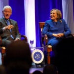 Former President Bill Clinton and former Secretary of State Hillary Rodham Clinton respond to audience questions on Saturday, Dec. 7, 2024 at the Robinson Center auditorium in Little Rock, Ark.