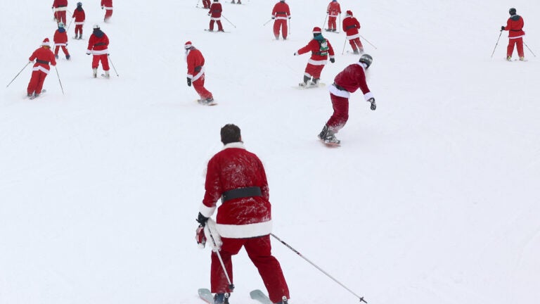 Skiers and snowboarders dressed as Santa in Newry, Maine.