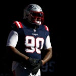 Christian Barmore walks onto the field for warmups.