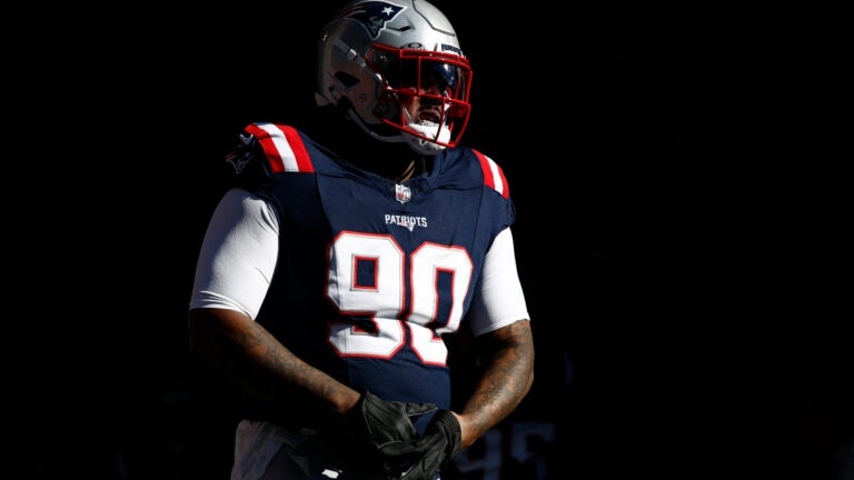 Christian Barmore walks onto the field for warmups.