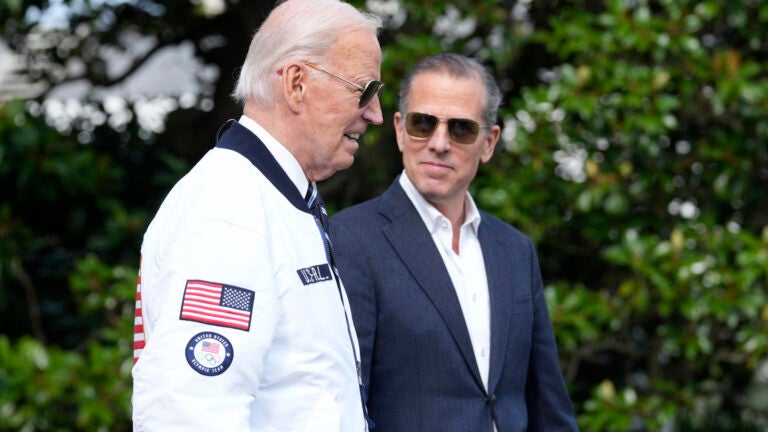 FILE - President Joe Biden, walking with his son Hunter Biden, heads toward Marine One on the South Lawn of the White House in Washington, July 26, 2024.