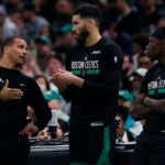 Boston Celtics head coach Joe Mazzulla talks to forward Jayson Tatum and guard Jrue Holiday in the first quarter at TD Garden.