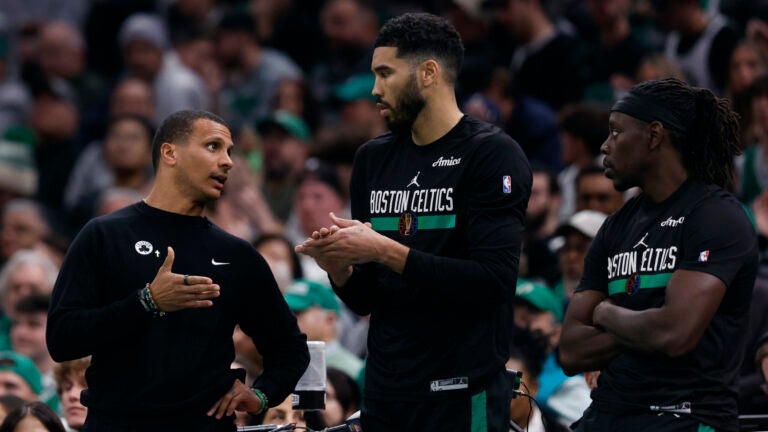 Boston Celtics head coach Joe Mazzulla talks to forward Jayson Tatum and guard Jrue Holiday in the first quarter at TD Garden.