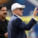 New York Jets owner Woody Johnson, right, chats with Jacksonville Jaguars owner Shad Khan on the field before an NFL football game, Sunday, Dec. 15, 2024, in Jacksonville, Fla.