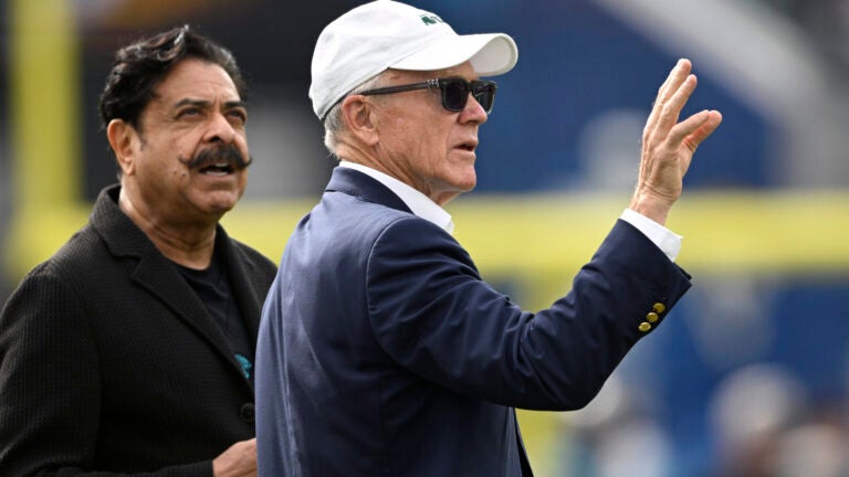 New York Jets owner Woody Johnson, right, chats with Jacksonville Jaguars owner Shad Khan on the field before an NFL football game, Sunday, Dec. 15, 2024, in Jacksonville, Fla.