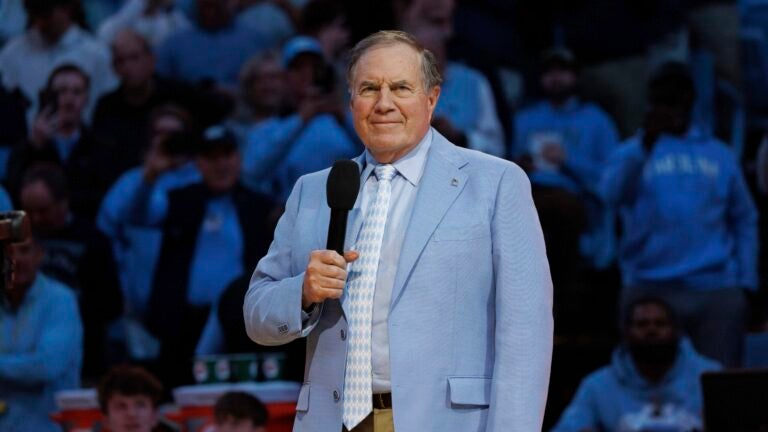 Bill Belichick speaks to the crowd at a UNC basketball game.