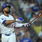 Los Angeles Dodgers' Teoscar Hernandez watches the flight of the ball that went foul during a baseball game against the Seattle Mariners, Tuesday, Aug. 20, 2024, in Los Angeles.