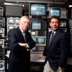 FILE -- Charles Dolan, left, with his son James Dolan in the control room of Cablevision Systems in Hauppage, on Long Island in New York, on April 27, 1997.