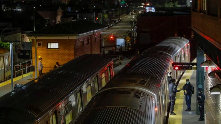 FILE - New York Police officers clear a train at the Coney Island Stillwell Avenue Terminal, May 5, 2020, in the Brooklyn borough of New York.