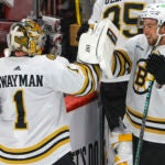 Boston Bruins goalie Jeremy Swayman (1) celebrates their 2-1 victory with teammate Charlie McAvoy (73) against the Florida Panthers during game five of the Eastern Conference NHL second round Playoff game at Amerant Bank Arena.
