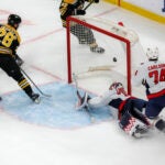 Bruins center Elias Lindholm scores past Washington Capitals goalie Charlie Lindgren during the third period.