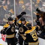 Boston Bruins Charlie Coyle (13), Trent Frederic (11) and Matthew Poitras (51) celebrate Frederic’s goal against the Tampa Bay Lightning in the first period at TD Garden.
