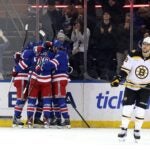 Mika Zibanejad of the New York Rangers celebrates with teammates after scoring a goal to reach 700 career points during the first period against the Bruins.