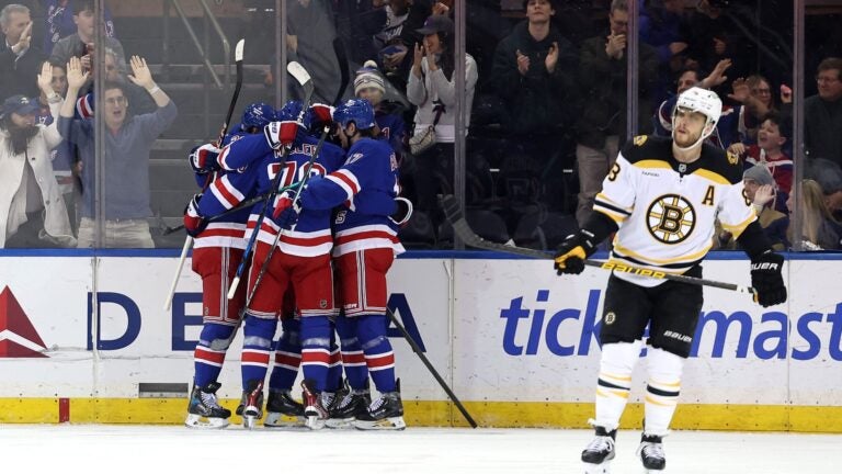Mika Zibanejad of the New York Rangers celebrates with teammates after scoring a goal to reach 700 career points during the first period against the Bruins.