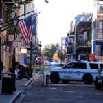 Emergency service vehicles form a security barrier.