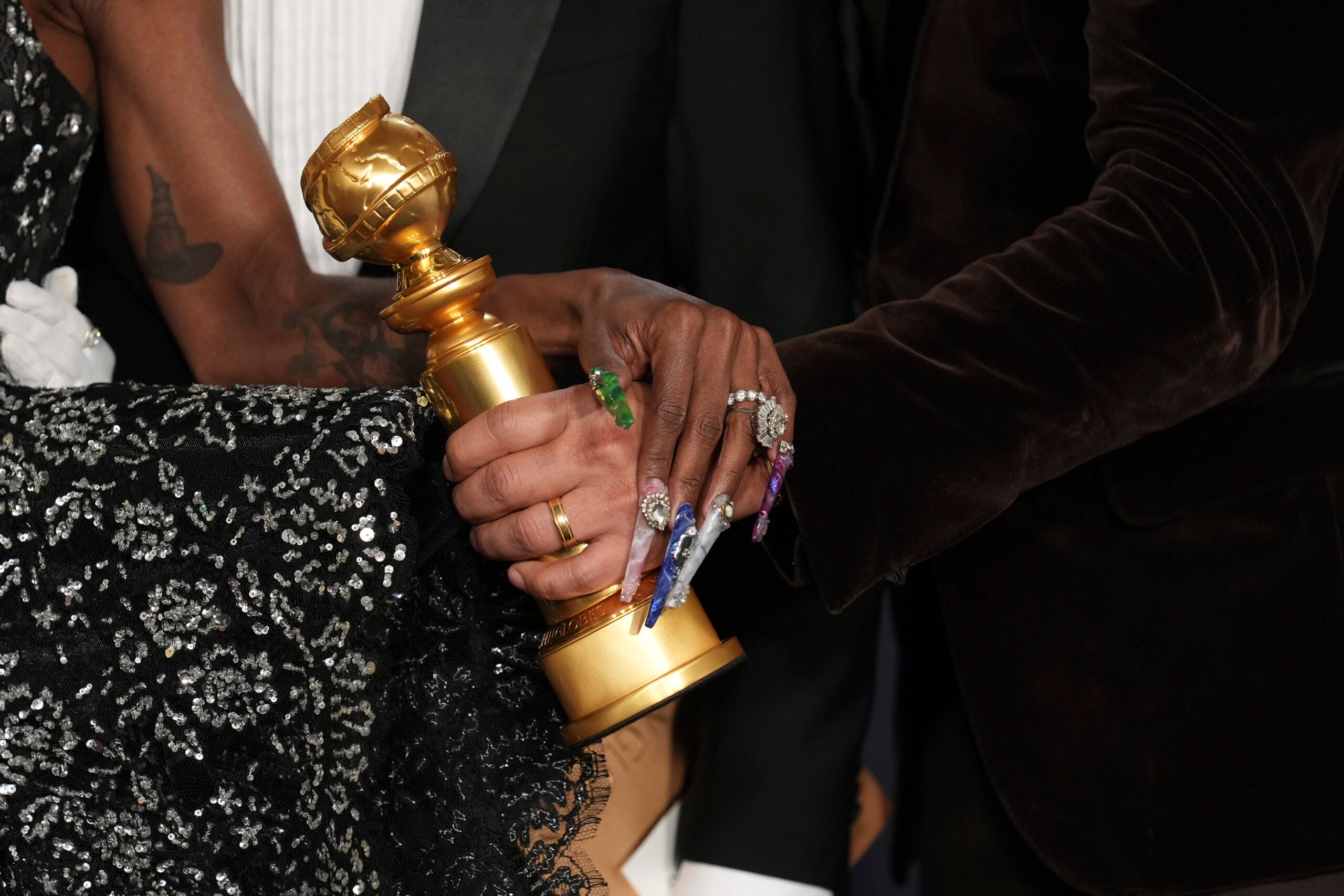 Cynthia Erivo and Jon M. Chu pose with an award.