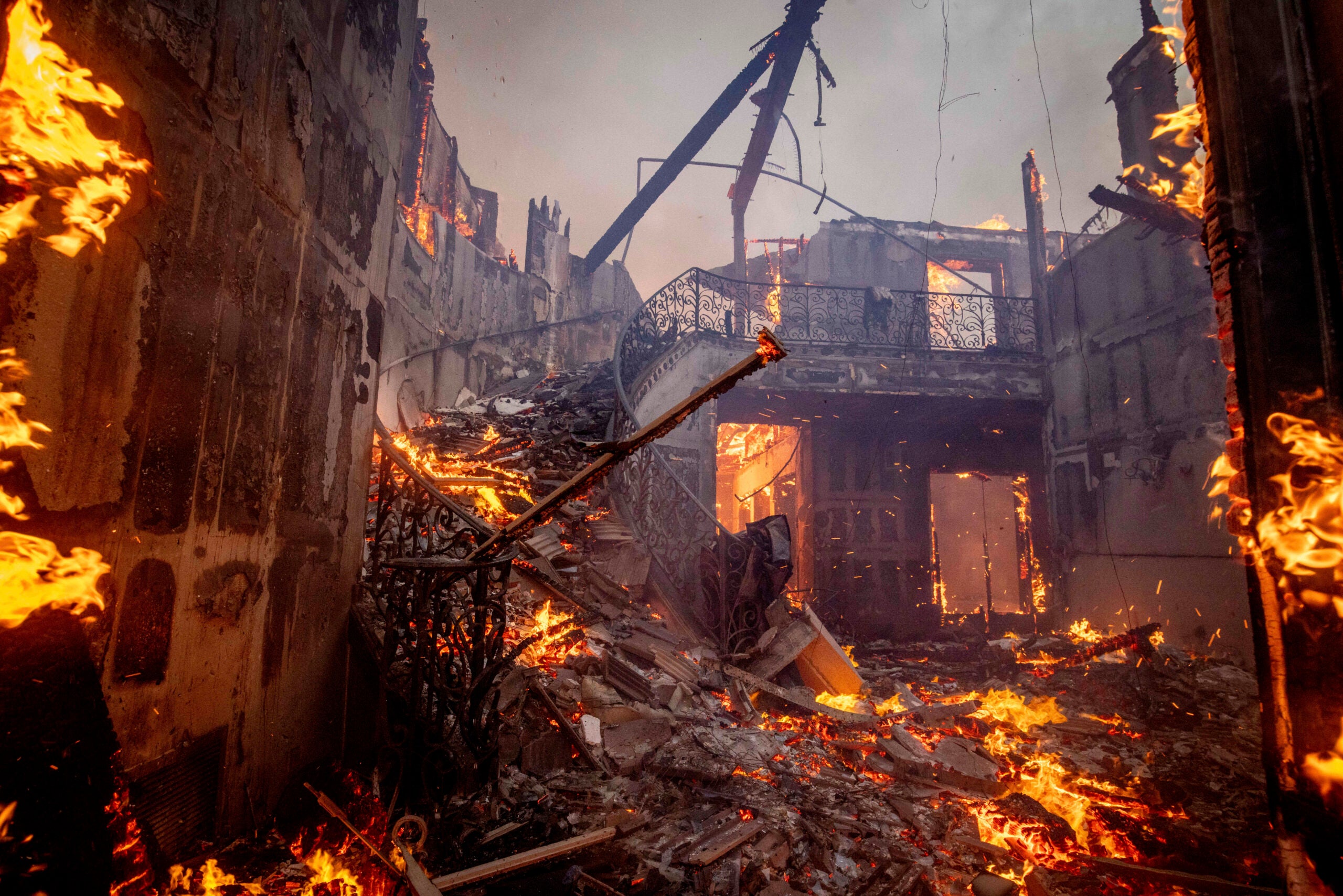 The Palisades Fire burns a residence.