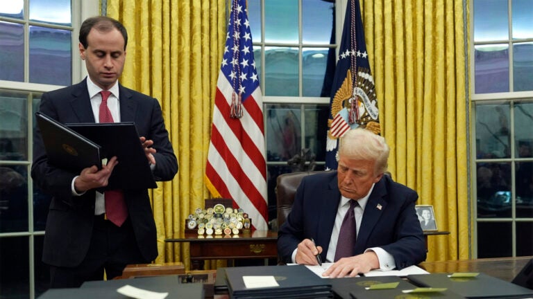 President Donald Trump signs an executive order.