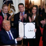 President Donald Trump holds the document after signing the Laken Riley Act during an event in the East Room of the White House, Wednesday, Jan. 29, 2025, in Washington.