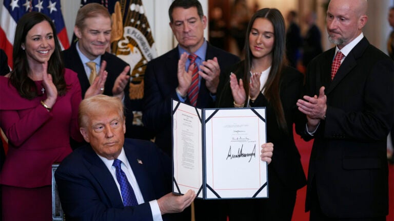 President Donald Trump holds the document after signing the Laken Riley Act during an event in the East Room of the White House, Wednesday, Jan. 29, 2025, in Washington.