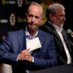 Boston Bruins chief executive officer Charlie Jacobs puts away his notes at the conclusion of a media availability, Monday, Sept. 30, 2024, in Boston.