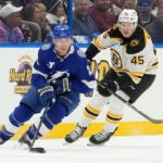 Tampa Bay Lightning center Brayden Point works around Bruins left wing Cole Koepke during the first period.
