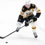 Boston Bruins defenseman Charlie McAvoy (73) chases the puck during the second period of an NHL hockey game against the Dallas Stars Thursday, Nov. 14, 2024, in Dallas.