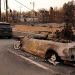 A car at right destroyed by the Eaton Fire sits next to an intact car, Thursday, Jan. 9, 2025, in Altadena, Calif.