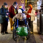 From left, Beckie Tachick, a nurse with the Boston Health Care for the Homeless Program, Jim Greene, Assistant Director for Street Homelessness Initiatives, Mayor’s Office of Housing, City of Boston, and two other volunteers conduct a welfare check with an unhoused individual in Boston, MA, during their annual homeless count in the early hours of Thursday, Jan. 30, 2025.