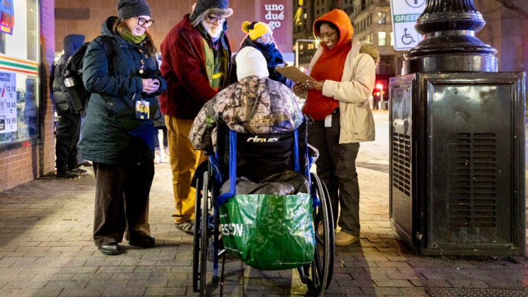 From left, Beckie Tachick, a nurse with the Boston Health Care for the Homeless Program, Jim Greene, Assistant Director for Street Homelessness Initiatives, Mayor’s Office of Housing, City of Boston, and two other volunteers conduct a welfare check with an unhoused individual in Boston, MA, during their annual homeless count in the early hours of Thursday, Jan. 30, 2025.