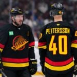 VANCOUVER, CANADA - JANUARY 25: J.T. Miller #9 of the Vancouver Canucks skates past Elias Pettersson #40 before the second period of their NHL game against the Washington Capitals at Rogers Arena on January 25, 2025 in Vancouver, British Columbia, Canada.