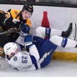 Boston Bruins defenseman Michael Callahan, left, drops Tampa Bay Lightning center Jack Finley to the ice during the first period of an NHL hockey game, Tuesday, Jan. 14, 2025, in Boston.