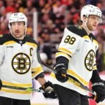 CHICAGO, ILLINOIS - DECEMBER 04: Brad Marchand #63 and David Pastrnak #88 of the Boston Bruins look on against the Chicago Blackhawks during the third period at the United Center on December 04, 2024 in Chicago, Illinois.